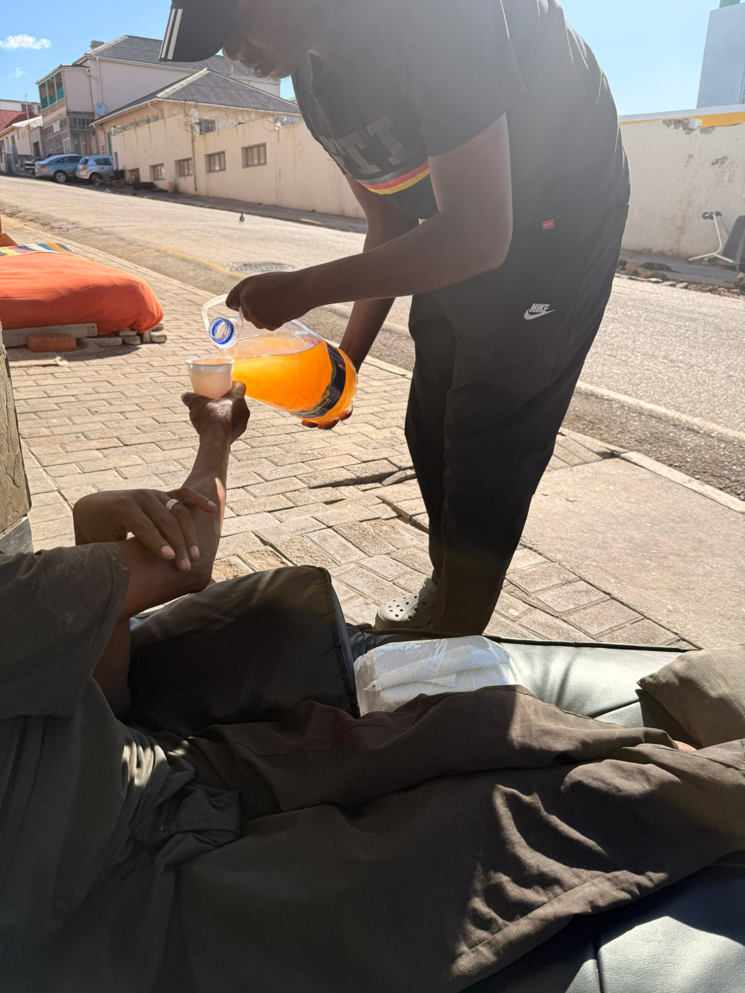 Drink being poured during a community feeding outreach